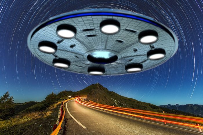 A depiction of a huge flying saucer over a lonely road