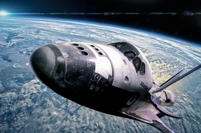 An image of a space shuttle high above the Earth