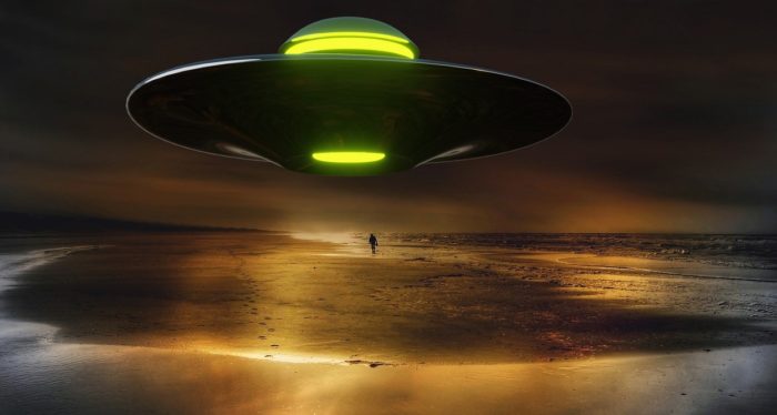 A superimposed UFO on a night beach