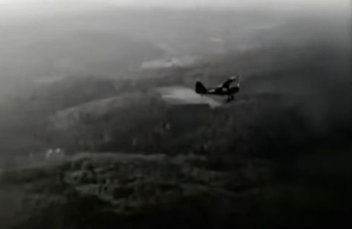 A picture of single engine plane flying over the countryside