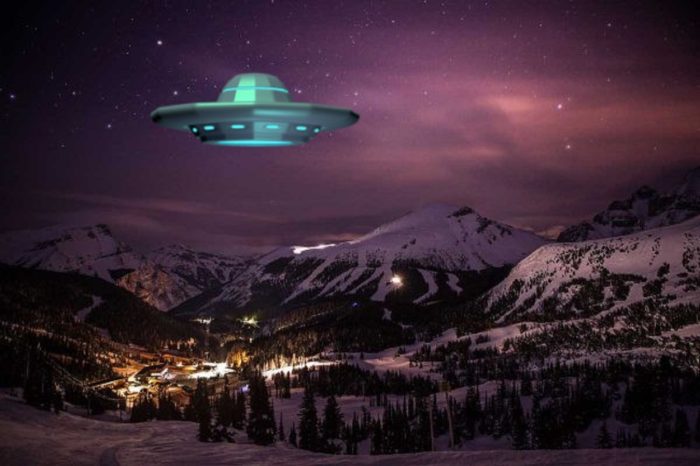 A UFO superimposed on a picture of lodge setting at night