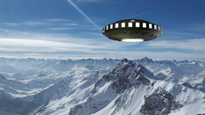 A UFO superimposed on a picture of a snowy mountaintop 