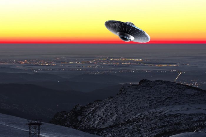 A UFO superimposed onto a picture of sunset sky