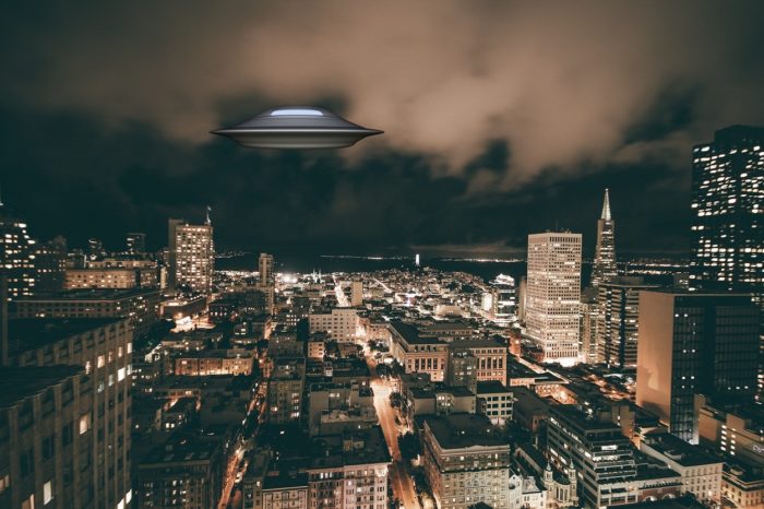 A superimposed UFO on a picture of city at night 