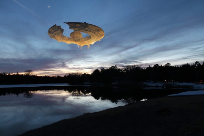 A superimposed UFO over a river at dawn