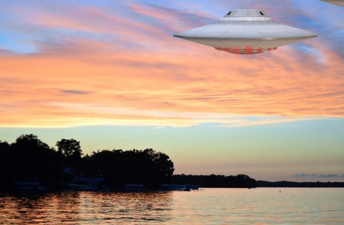 A superimposed UFO over the water at dawn