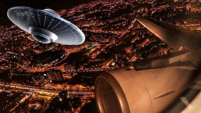 A picture of an aerial view of a plane with a superimposed UFO over the top