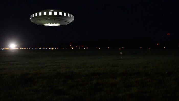 A superimposed UFO on a picture of a field at night