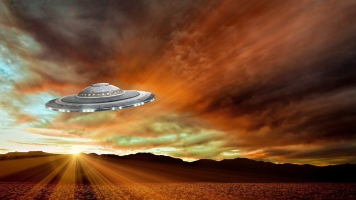 A superimposed UFO on a picture of a dawn sky