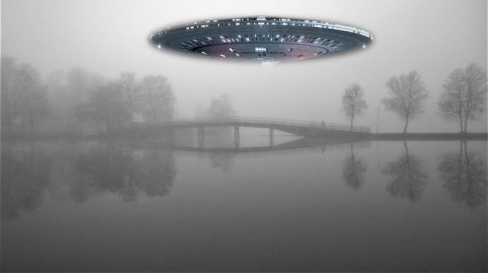 A superimposed UFO over a picture of a misty lake