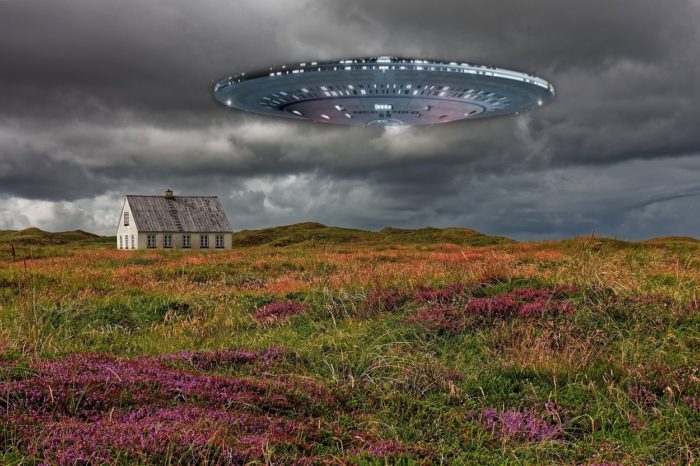 A superimposed UFO over an image of a lone house in a field with grey skies