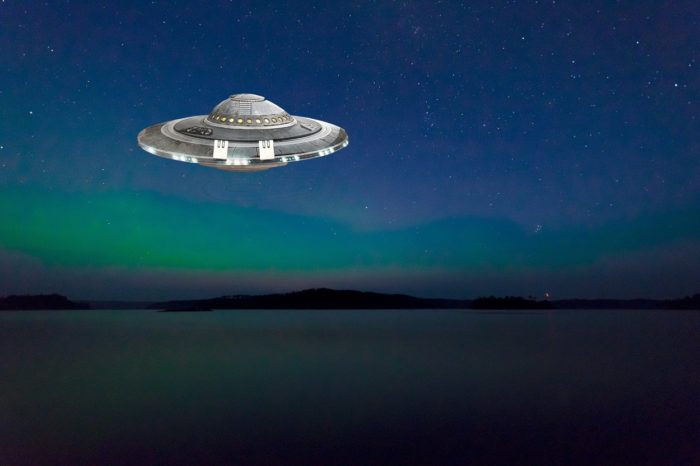 A superimposed UFO over a picture of a river at night