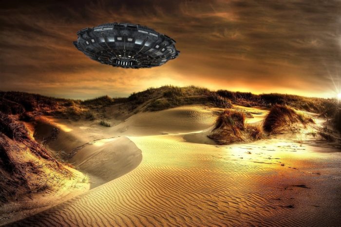 An image of a UFO over a sandy landscape