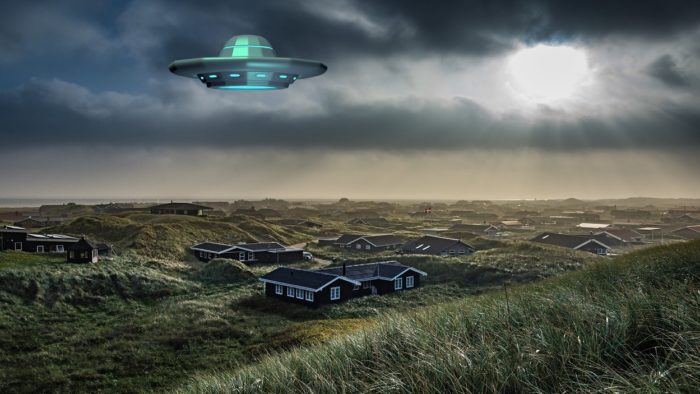 A superimposed UFO over an image of a small country village