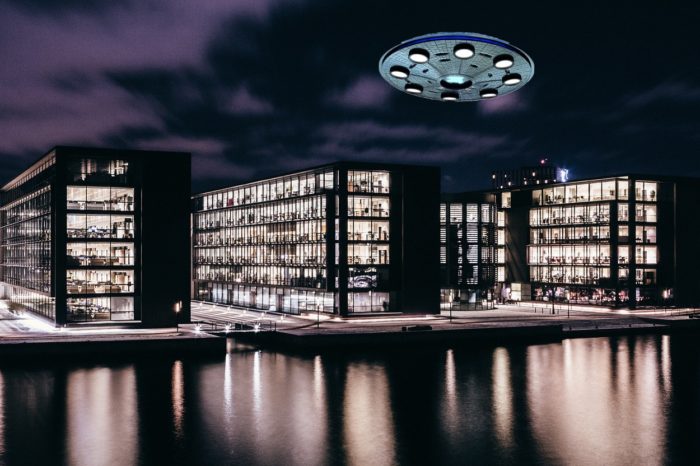 A superimposed UFO over a block of flats at the waterside