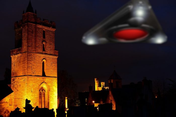 A superimposed triangular UFO over a picture of a church at night