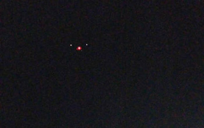 A picture showing an alleged triangular shaped UFO with lights at each corner