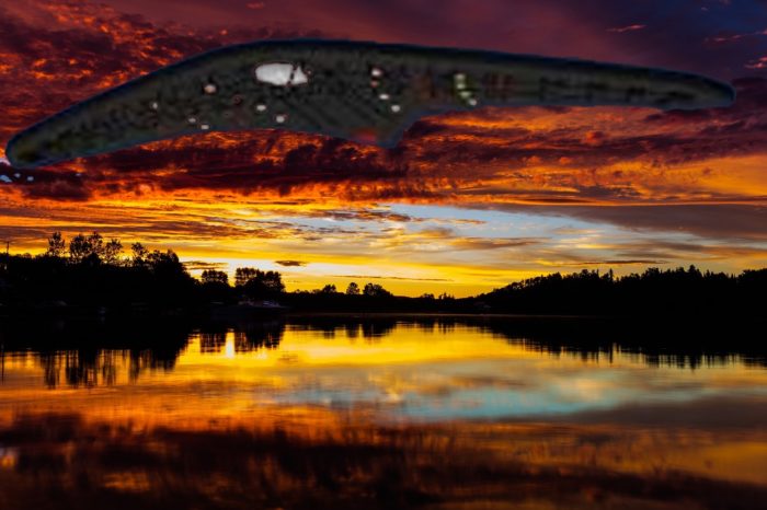 A depiction of a UFO over the water at sunset