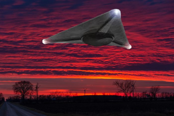 A superimposed triangular UFO with a red sunset sky behind