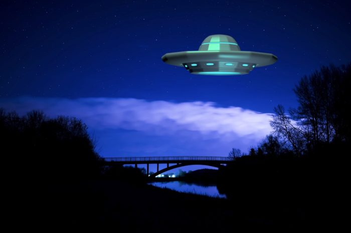 A picture of a UFO over a river at night