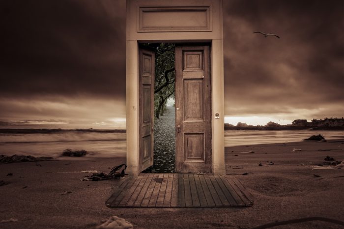 A mystical image of a door in the middle of desert