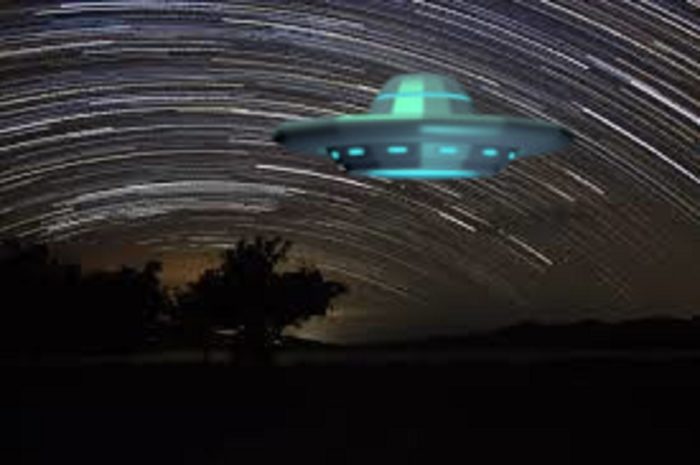 An image of a UFO over a time-lapsed night sky