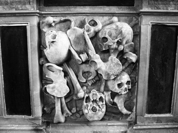 Skull and bones cemented in a wall