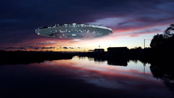 A superimposed UFO onto a picture of sunset river