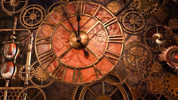 A close up of clock with several dials and cogs