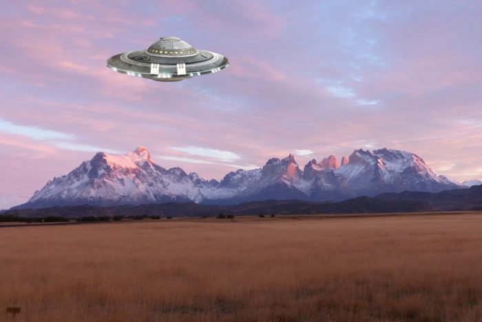 An image showing a UFO over a mountain range