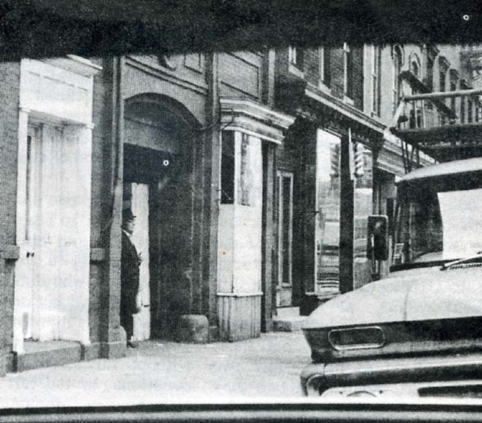 A picture showing an alleged member of the Men In Black in a New York apartment black doorway