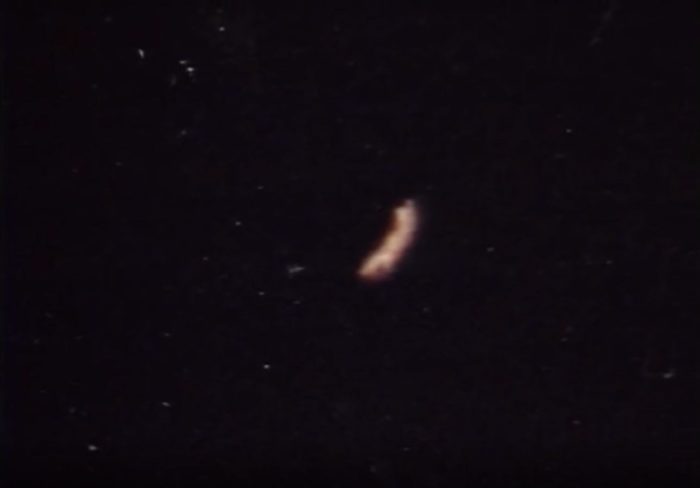 A picture showing an alleged orange UFO in a starry night sky