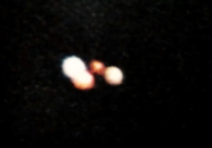 A picture showing an alleged orange glowing UFO at night
