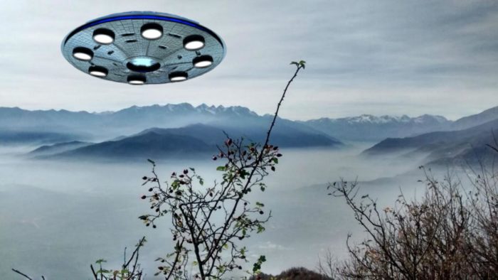 A UFO superimposed onto a cloud mountain top image