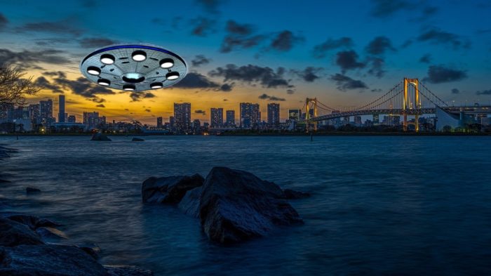 A UFO superimposed on to a picture of the water with a city in the background