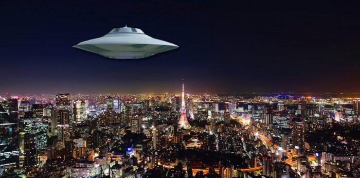 A UFO superimposed on to a picture of a Japanese city at night