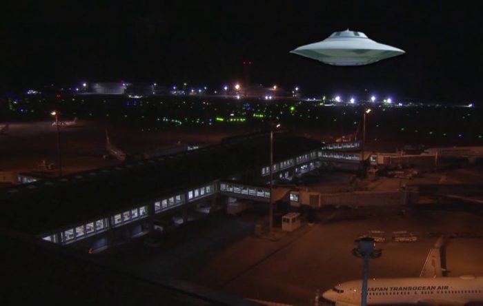 A UFO superimposed on to a picture of an air base at night