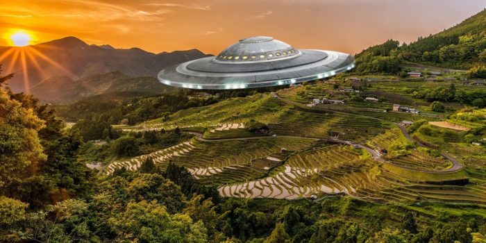 A flying saucer superimposed onto an aerial view of the countryside