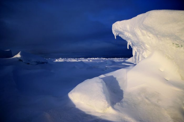 The icy world of Antarctica with dark blue sky