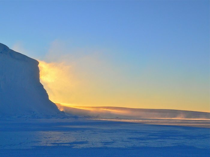 The sun reflects off the ice of Antarctic terrain