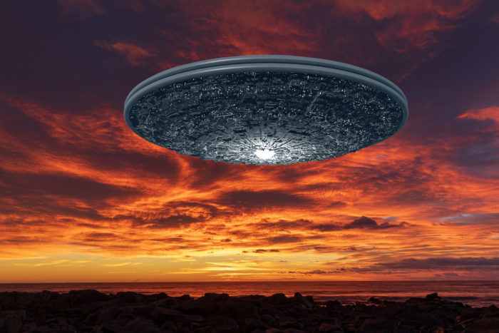 Superimposed UFO in a sunset sky