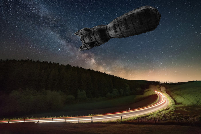 Superimposed UFO over a road at night