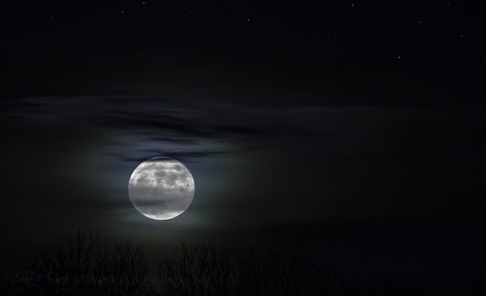 A full moon in a night sky