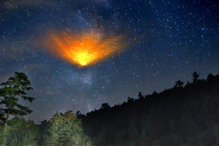 A superimposed fireball over trees