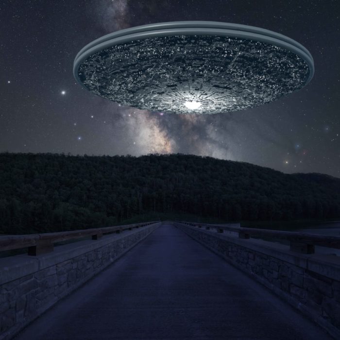 A superimposed UFO over a quiet road