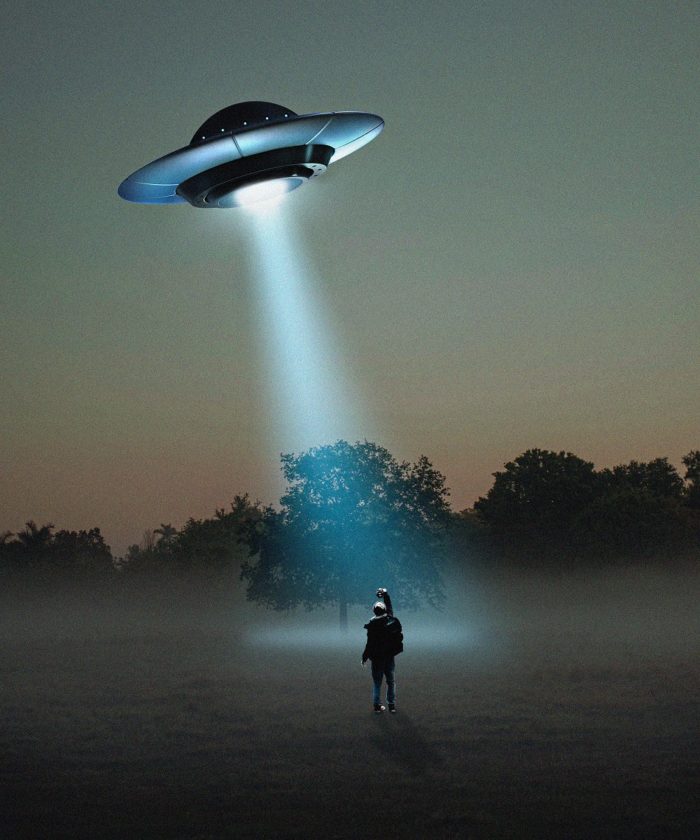 A depiction of a flying saucer over a person