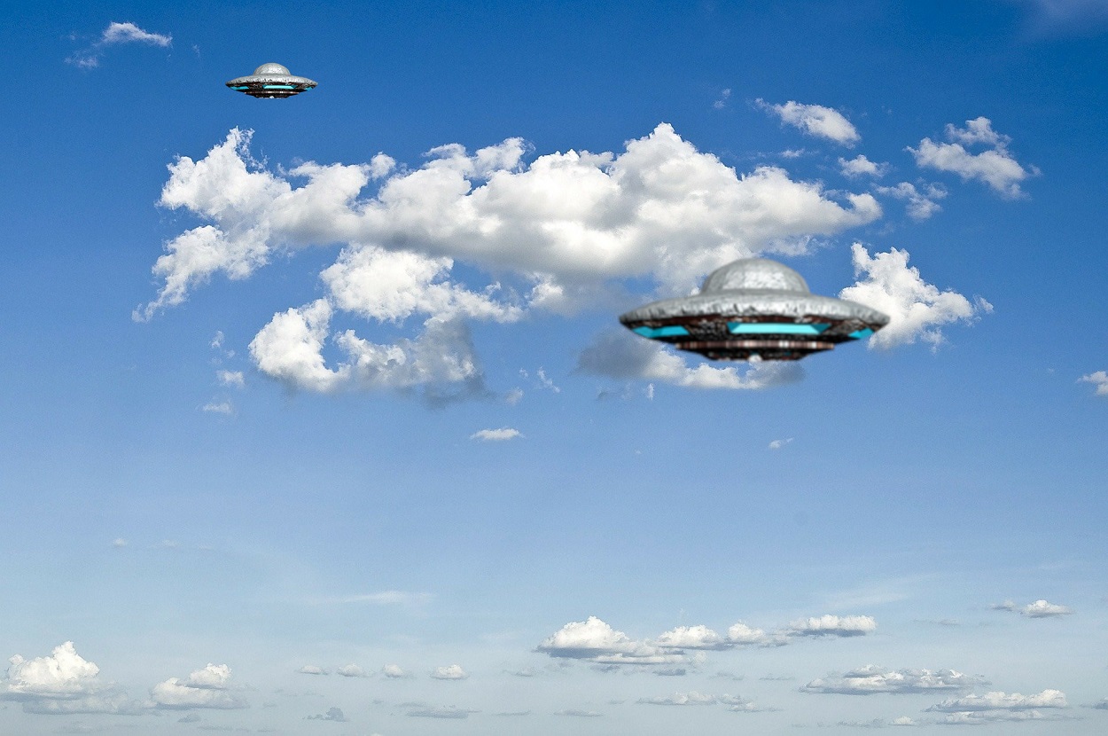 A depiction of two UFOs in the day sky