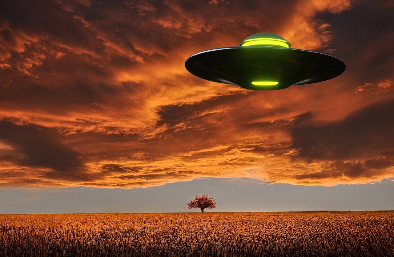 A depiction of a UFO over a field