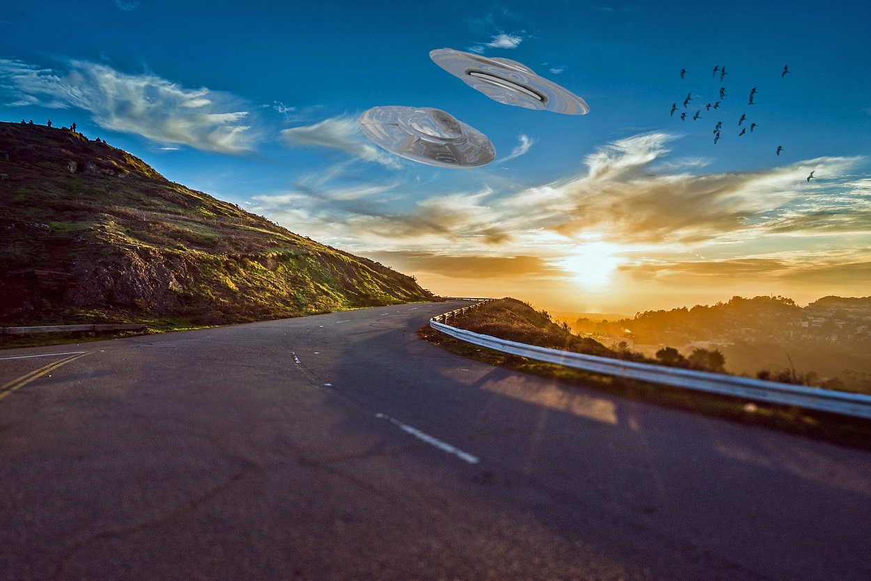 A depiction of a UFO over the highway