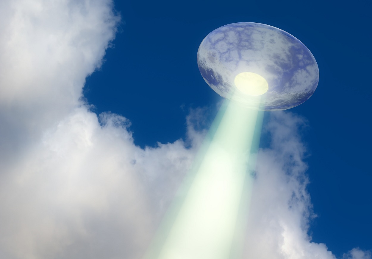 A depiction of a UFO shining a beam to the ground